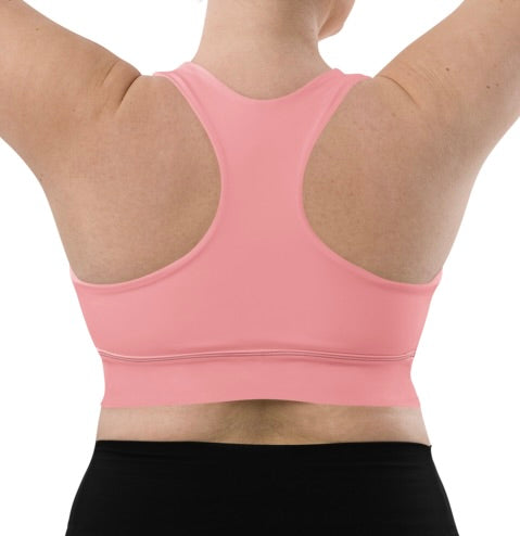 Plus-size model in solid pink longline sports bra.